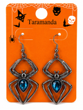 A pair of silver-toned spider drop earrings with blue teardrop rhinestones, displayed on an orange Halloween-themed card labeled 'Taramanda'.