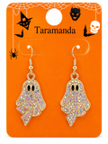 A pair of gold-tone ghost drop earrings covered in iridescent rhinestones, displayed on an orange Halloween-themed card labeled 'Taramanda' with spiderwebs, bats, a witch hat, and a skull.