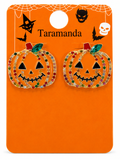 A pair of Halloween pumpkin stud earrings on an orange backing card. The earrings are gold-tone with rhinestone trim in red, green, and clear, and feature black enamel jack-o'-lantern faces.