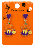 A pair of Halloween-themed dangle earrings on an orange display card. The earrings feature a purple heart-shaped top, a pumpkin character wearing a purple dress with a yellow bow, and a small yellow pumpkin bag.