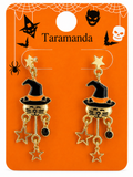 A pair of gold and black witch cat dangle earrings on an orange Halloween-themed display card. The card features spiderwebs, spider silhouettes, bat silhouettes, a skull, and the text 'Taramanda' at the top.