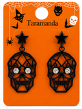 A pair of black skull drop earrings with star-shaped studs and rhinestone eyes, displayed on an orange Halloween-themed card labeled 'Taramanda'.